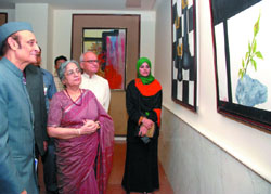 Prime Minister Manmohan Singh's wife Gursharan Kaur with former union minister Karan Singh during a painting exhibition by young women artists from Afghanistan at Indira Gandhi National Centre for Arts in New Delhi 