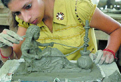 A girl gives finishing touches to her terracotta model at the concluding day of an art workshop in Jalandhar on Monday.