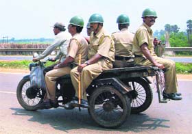 Policemen return from the protest site in Singur on Monday after the Trinamool Congress chief Mamata Banerjee called off her partys dharna against the Tatas car plant