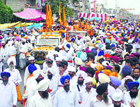 Devotees participate in a nagar kirtan marking the end of Guru Nanak Devs marriage anniversary celebrations in Batala on Monday.