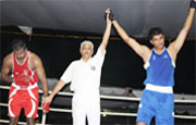 Referee declaring Baljeet of Chandigarh (Blue) winner who defeated the Arjuna Awardee V. Johnson of SSCB (Red) during the fourth day of the 55th Senior National Boxing Championship in Bathinda