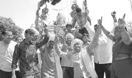 Devotees dance in front of the idol of Lord Ganesha on a rath during the Ganesh Visarjan Rath Yatra taken out in Ambala Cantonment on Tuesday. 