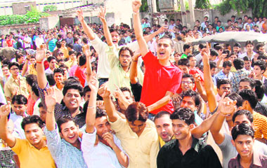 Students of the Doon Valley Institute of Management stage a protest against the imposition of a dress code in Karnal on Tuesday.