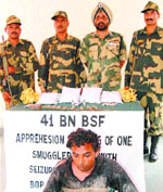 BSF officials along with captured smuggler at the Indo-Pak border in Amritsar. 