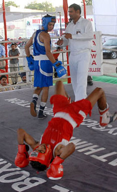 Santosh (red) of Goa falls in the bout against Ashwani Sharma of AIP.