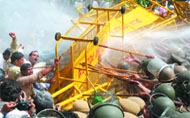 The Delhi police uses water cannons to disperse protesting farmers at Delhi Vidhan Sabha in New Delhi