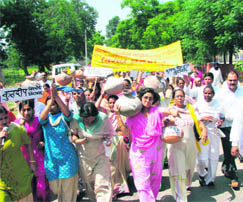 Haryana Janhit Congress women carry pitchers before breaking them in front of the mini secretariat as part of an anti-government protest at Kurukshetra on Wednesday.
