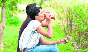 ON A HIGH: Two youths have beer in the open, regardless of what the law says on the issue, near the Daulat Singh Park in Shimla 