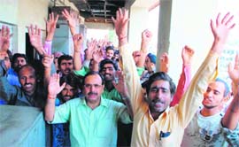 Employees of the Public Health Engineering Department hold a demonstration in support of their demands in Jammu on Wednesday