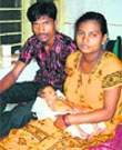 Mani and Baliyath Naik with their newborn child Lotus at the Community Health Centre in G Udaygiri block of Kandhamal.