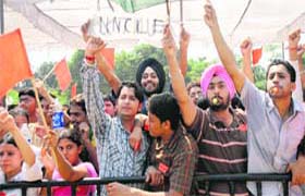 Students raise slogans during the open house at Panjab University