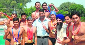 Elated players of DAV College, who won the Panjab University Inter-college Swimming Championship, in Chandigarh