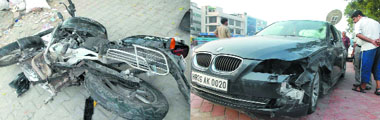 The bike hit by a BMW car (right) near Moolchand flyover in New Delhi on Thursday.
