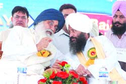 Punjab CM Parkash Singh Badal talks to Baba Malkiat Singh at the sixth foundation day of Sant Baba Bhag Singh Educational Complex at Khiala village in Jalandhar on Thursday