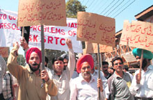 Employees of the JKSRTC shout slogans during a demonstration in Srinagar on Thursday.