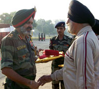 Lt-General R.S. Sujlana honouring an ex-serviceman during the Saragarhi Day function in Ferozepur. 