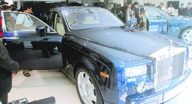 Media representatives gather to take pictures of a Rolls-Royce Phantom displayed at the opening of a Rolls Royce Motor Cars showroom in New Delhi on Friday. Rolls-Royce opened its second showroom in India, first being in Mumbai