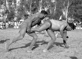 Wrestlers try to outbeat each other in a competition at Pabri near Rajpura on Friday.