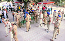 Police personnel stand guard on the PU campus on Friday.