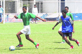 A participant takes part in a high jump; and (right) a football match in progress during the block-level tournament being organised at Guru Nanak Stadium in Ludhiana.