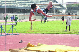A participant takes part in a high jump; and (right) a football match in progress during the block-level tournament being organised at Guru Nanak Stadium in Ludhiana.