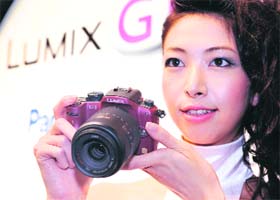 A model displays Matsushita Electric Industrials Lumix DMC-G1, the world's first digital interchangeable lens camera that is based on the new Micro Four Thirds System Standard, in Tokyo on Friday.