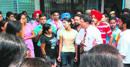 Panjab University V-C R.C. Sobti pacifies protesting students of Sarojini Hall on Saturday.