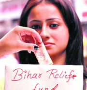 A student of RKMV College collecting money for the Bihar Relief Fund in Shimla on Saturday.