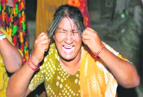 A woman cries after losing her relative in Karol Bagh