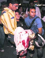 An injured woman being taken to hospital after a bomb blast near Gopaldas Building at Connaught Place in New Delhi