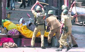 A protester under attack in Srinagar