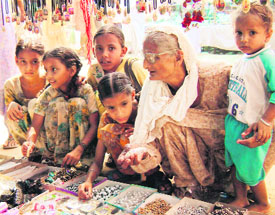 an old woman makes a purchase with her grandchildren at the mela at Ahmedgarh on Saturday.