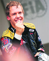 Toro Rossos German driver Sebastien Vettel celebrates in the parc ferme of the Monza racetrack after the qualifying session of the Italian Formula One Grand Prix on Saturday.