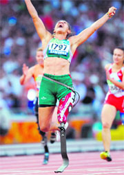Perla Bustamante of Mexico celebrates after winning the final of the womens 100 metre T42 classification event at Paralympic Games. 