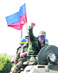 Russian troops move along a road outside the Georgian town of Zugdidi
