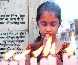 A girl pays homage to the victims of the Delhi blasts in Karnal on Sunday.