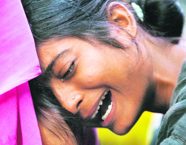 A relative of a bomb blast victim mourns in New Delhi on Sunday.