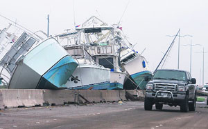 A truck moves next to damaged boats on the I-45 highway after Hurricane Ike in Galveston, Texas, on Saturday. 