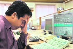 A stockbroker reacts as Sensex slumps, in Mumbai on Monday.