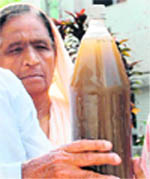 A resident shows muddy water that is being supplied by the public health department in Phase X, Mohali.