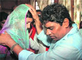Bollywood comedian Johny Lever blesses a woman after a special prayer meeting against recent clashes between Hindus and Christians in Orissa, in Shimla