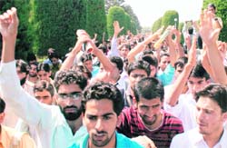 Students of Kashmir University raise pro-freedom slogans during a protest in Srinagar on Monday. 