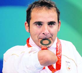 Swimmer Daniel Vidal of Spain holds his bronze medal after the mens 4x50m medley 20 PTS final during the 2008 Beijing Paralympic Games