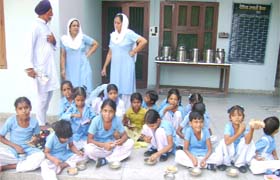 Students reluctantly eat the rotten food offered to them under the revised mid-day meal scheme in a government school of Abohar