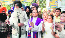 SAD (Amritsar) president Simranjit Singh Mann and members of the National Christian League hold a candlelit vigil in Chandigarh on Tuesday.