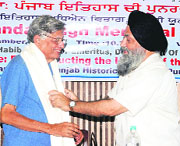 Vice-chancellor Jaspal Singh honours Irfan Habib during a seminar at Punjabi University in Patiala, on Tuesday.