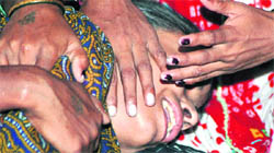Yoshodhara, who lost her husband in the bomb blast in Delhi's Gaffar market on Saturday, being consoled by relatives on Tuesday.
