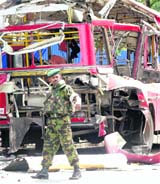 A Sri Lankan military officer inspects the scene of the bomb explosion in Colombo on Wednesday.  Reuters
