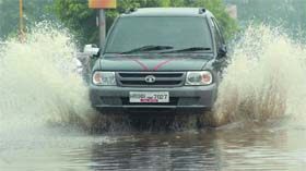 A car passes through a waterlogged road at ITO