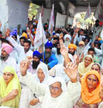 Farmers protest near the office of the deputy commissioner in Amritsar 